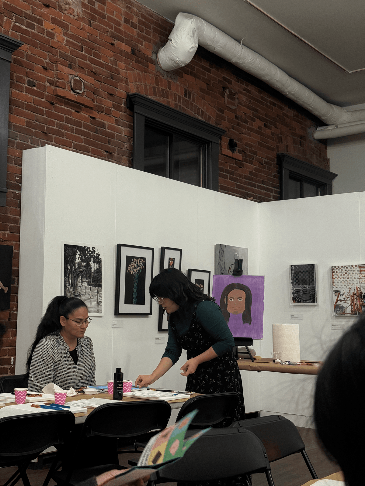 Visitors painting during the paint-and-sip workshop at Slip Gallery
